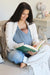 Child in nesting days carrier, mother in Waffle Weave Creme Robe