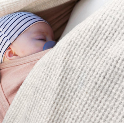 child in nesting days carrier